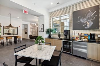 a kitchen and dining area with a table and chairs